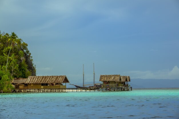 Evening Houses on Stilts and Two-Masted Schooner