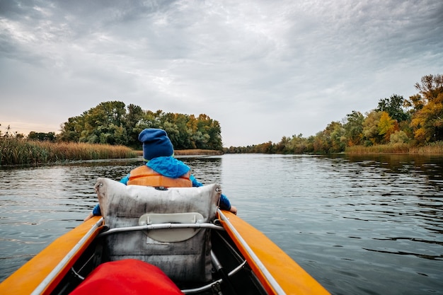 Evening kayak trip along the river in autumn