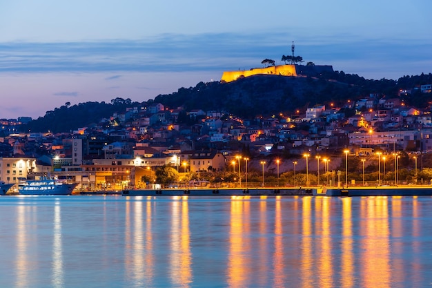 Evening Sibenik city in Croatia night city lights reflection cityscape