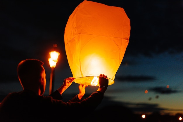 In the evening, at sunset, people with their relatives and friends launch traditional lanterns