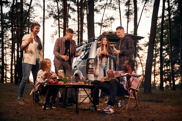 Evening time by the table Group of friends are together in the forest