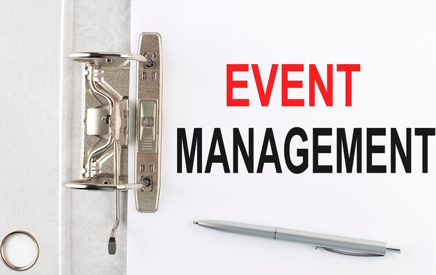 EVENT MANAGEMENT text on the paper folder with pen Business concept