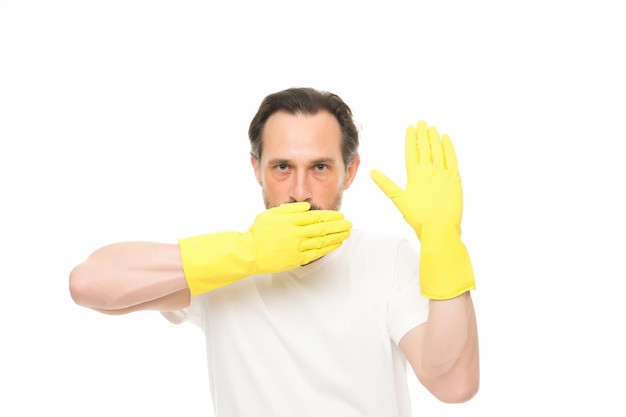 Everyday routine with domestic duties. man cover mouth with hand. have no rights. mature man wear rubber gloves. man cleaning home. care your hands while washing dishes. hand skin protection.