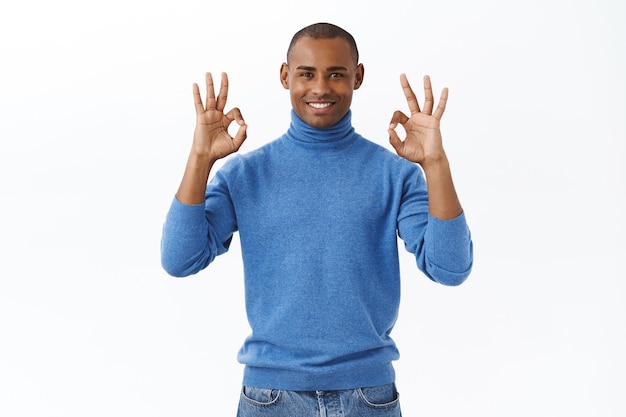 Everything under control. Portrait of satisfied, confident african american man smiling, assuring all good, show okay gesture nod agreement