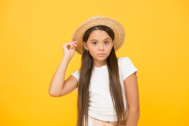 Everything must be perfect kid fashion and beauty happy childhood harvest and farming concept warm spring day child in straw beach hat summer holiday and vacation great mood and leisure time