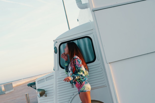 Everything should be perfect. attractive young woman looking in the mirror while standing against food truck outdoors