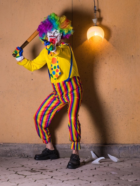 evil clown with baseball bat