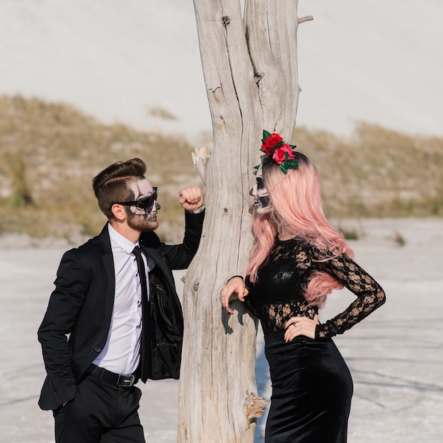 Evil day of the dead undead couple posing, halloween make up