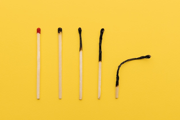 Photo evolution of matches from new to completely burnt as a symbol of aging or burnout