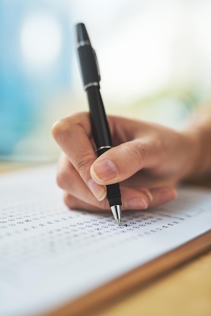 Exam in progress Shot of a woman filling in an answer sheet for a test