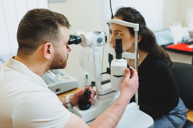 Photo examination of vision on modern ophthalmological equipment eye examination of a woman at an ophthalmologist's appointment using microscopes vision treatment at an ophthalmologist appointment