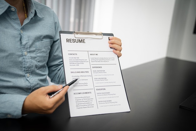 Examiner reading a resume during job interview at office Business and human resources concept