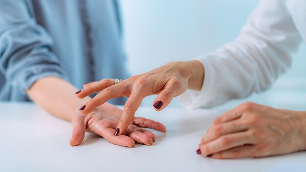 Examining Hand of Senior Patient with Carpal Tunnel Syndrome Closeup Image of Senior Woman's Wrist