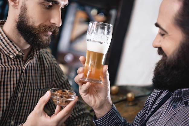 Photo examining lager beer and hop of high quality.