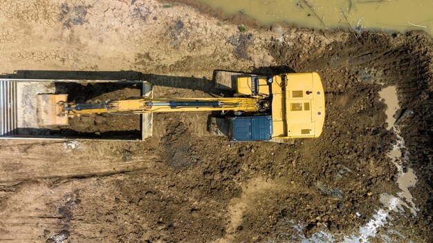 Excavating soil into a dump truck to build a pond for store water for use in the dry season