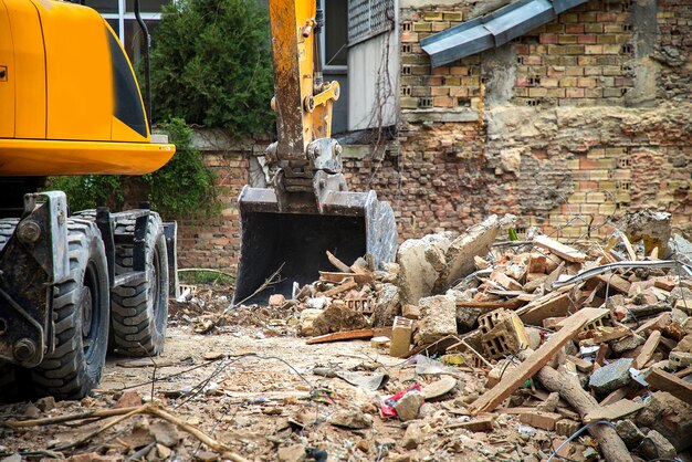 Excavator breaks old house freeing up space for the construction of a new building