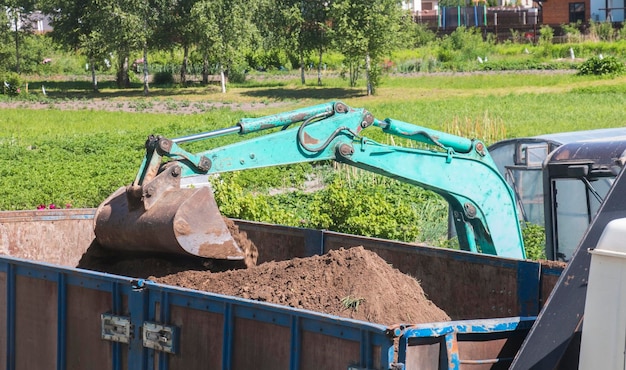 Excavator bucket digs sand