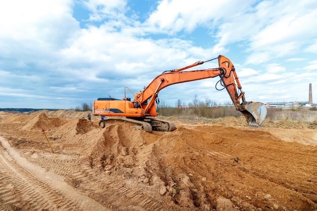 Excavator dig the trenches at a construction site trench for laying external sewer pipes