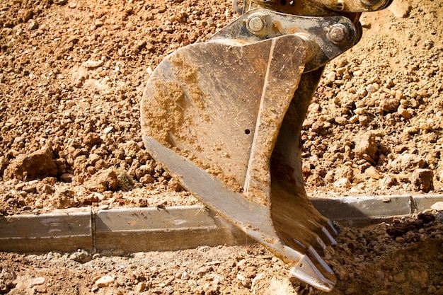 Excavator digging a deep trench, working