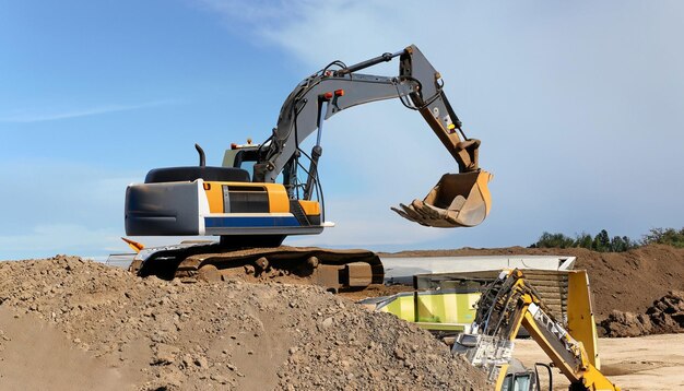 Excavator digging in the ground against the blue sky