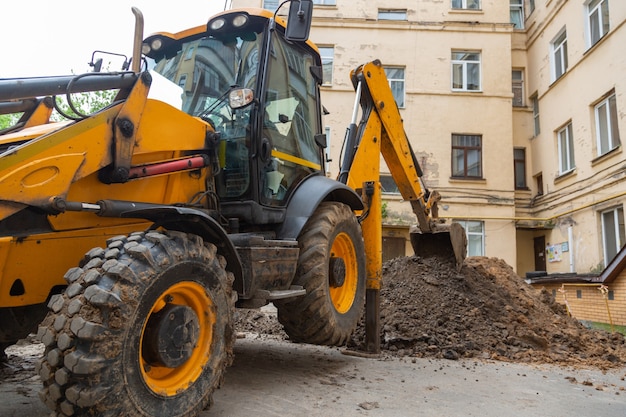 Photo excavator digs a trench