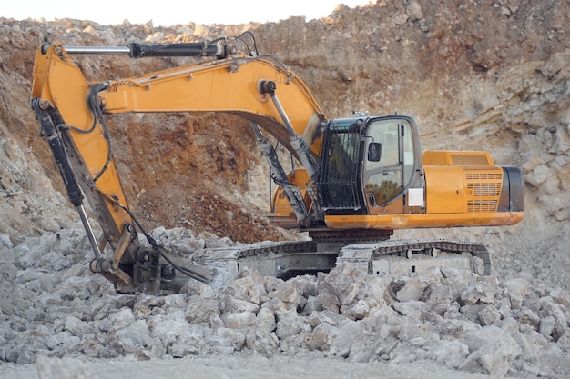 excavator is in the quarry at daytime no people