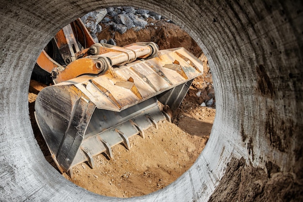 The excavator loader works with a bucket for transporting sand at a construction site Professional construction equipment for earthworks