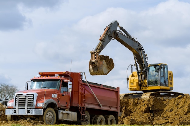 Excavator loading sand in rearend tipper