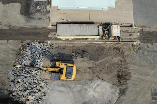 Excavator scooping rocks stone construction