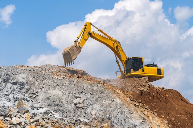 Excavator working outdoors under blue sky