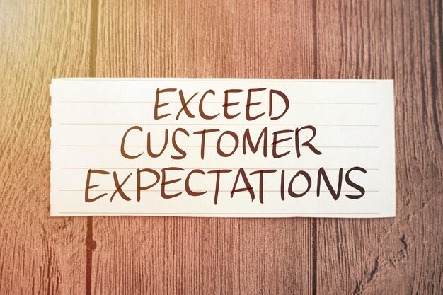 Photo exceed customer expectations text words typography written on paper against wooden background