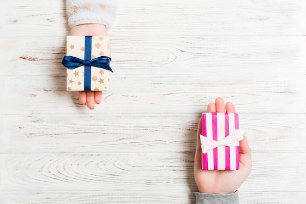 exchange of Christmas gift box on colorful background