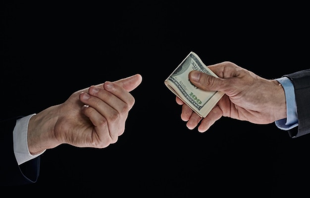 Exchange of money cards between businessmen closeup