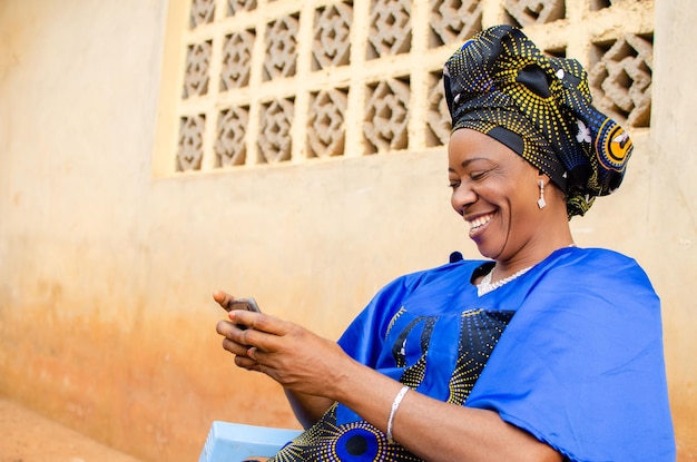 Excited aged woman playing game on her smartphone