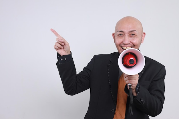 Photo excited asian businessman speak loudly using megaphones while pointing aside announces good news or