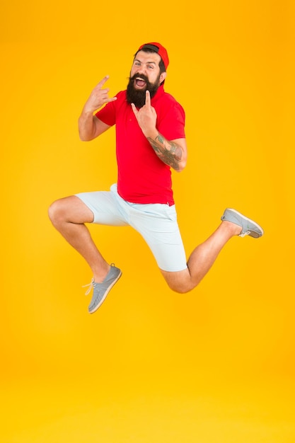 Excited bearded man jumping. full of energy. Impetuous movement. dedicated to sport and fitness. active runner in move. Always in motion. Success and happiness.