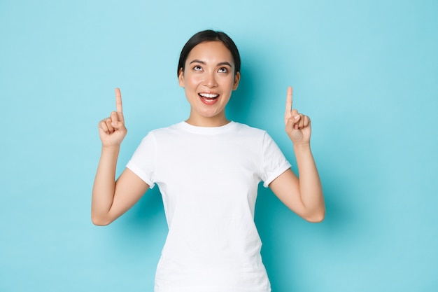 Excited beautiful asian girl in white t-shirt