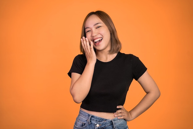 Excited beautiful woman feeling joy laughing on isolated background