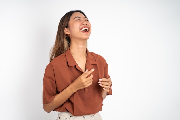 Excited beautiful woman feeling joy laughing on isolated background