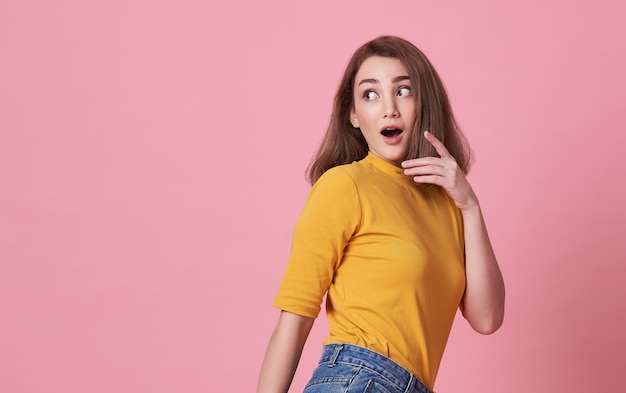 Excited beautiful woman with open mouth wearing casual t shirt 