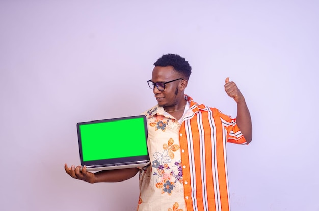 Excited black african guy holding laptop computer with empty black screen