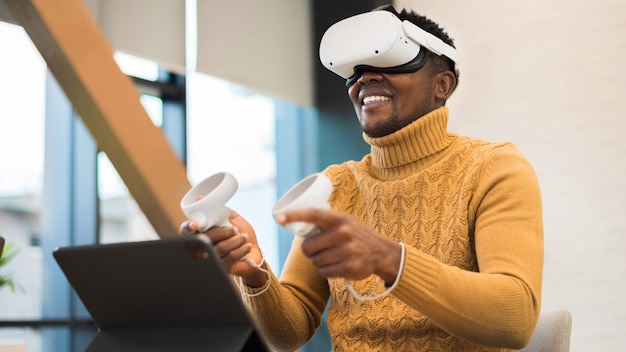 An excited black man exploring virtual reality in an office