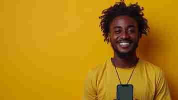 Photo excited black man showing smartphone empty screen recommending app over yellow studio background smiling to camera check this out cellphone display mockup