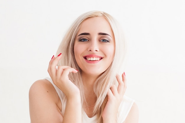 Excited blonde gesturing woman on white