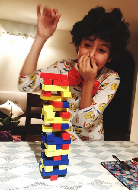 Photo excited boy playing block removal game at home