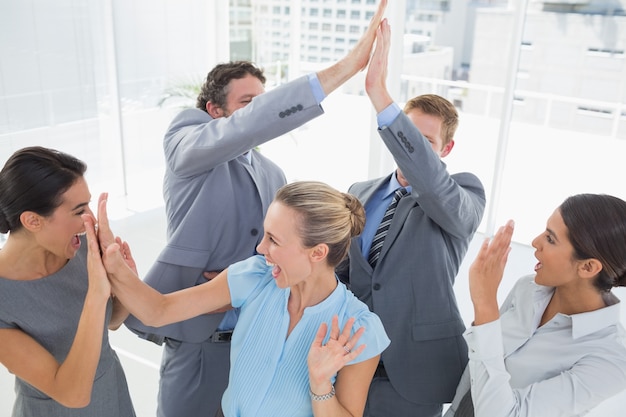 Excited business team cheering 