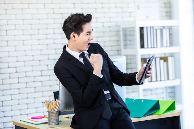 Excited businessman in his office