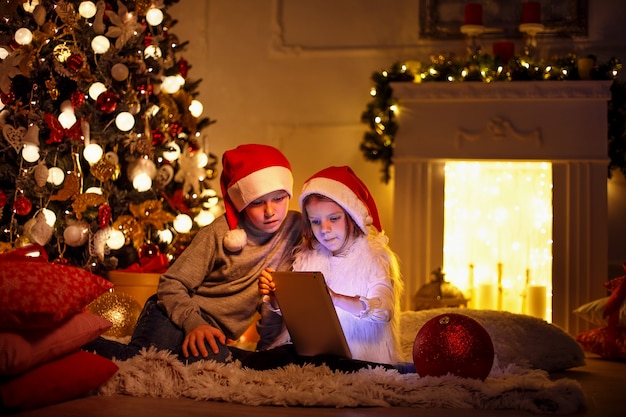 Excited children near Christmas tree