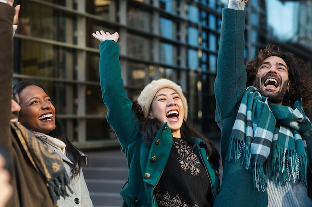 Photo excited colleagues celebrating success together with colleagues on city street