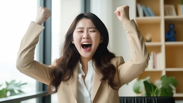 Excited cute asian business woman celebrating successful financial project results